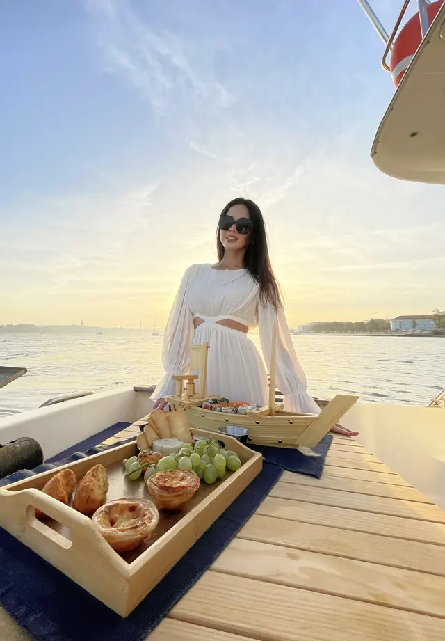 A golden hour picnic tray on a boat deck