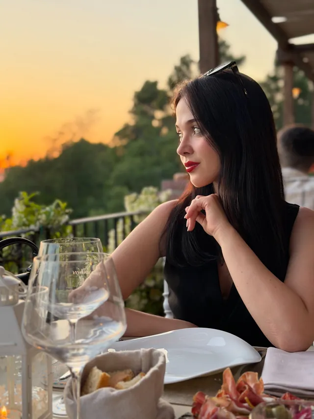 A golden hour dinner with wine glasses at sunset