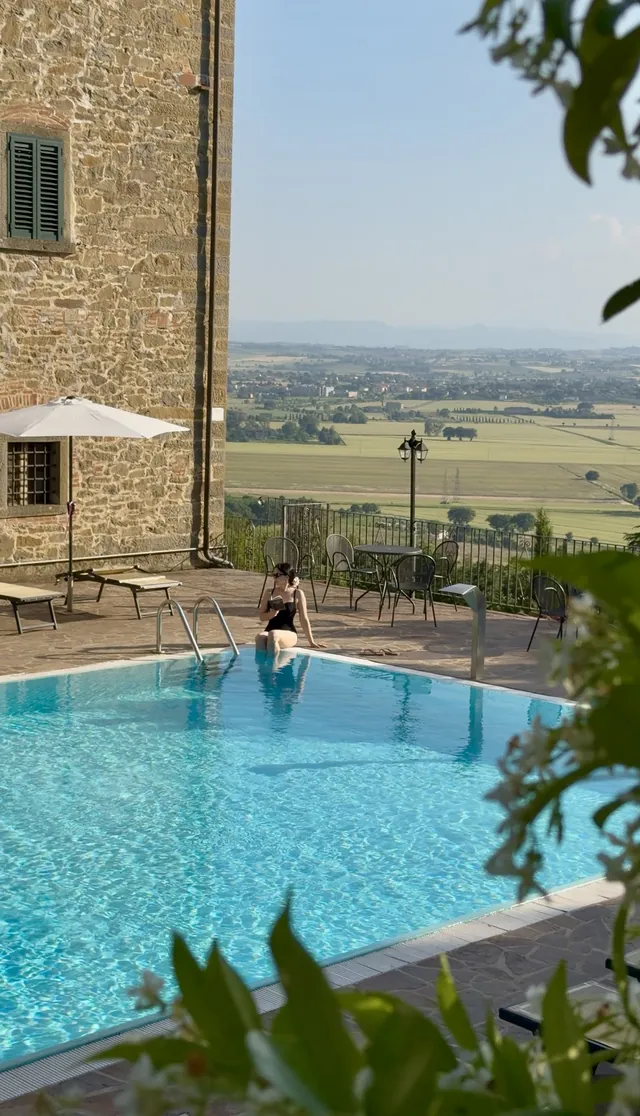 A villa pool and sun lounger overlooking the countryside